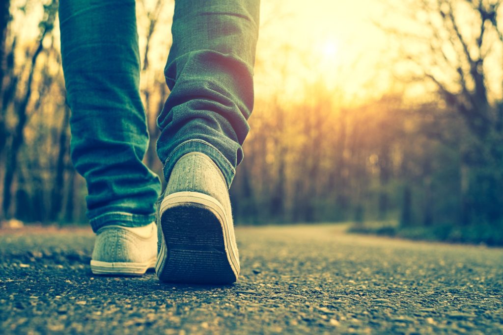 A close-up of someone walking on a path.